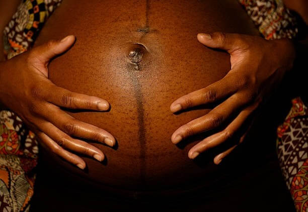 Black woman's pregnant belly